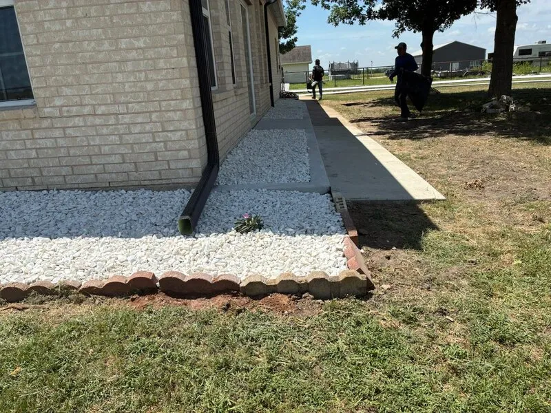 Concrete Walkway & Drainage — New walkway with gravel border and red brick edging