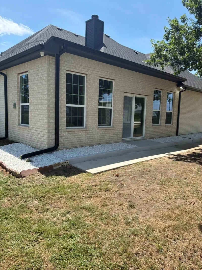 Concrete & Gravel Installation — Walkway extension with decorative gravel and red brick border